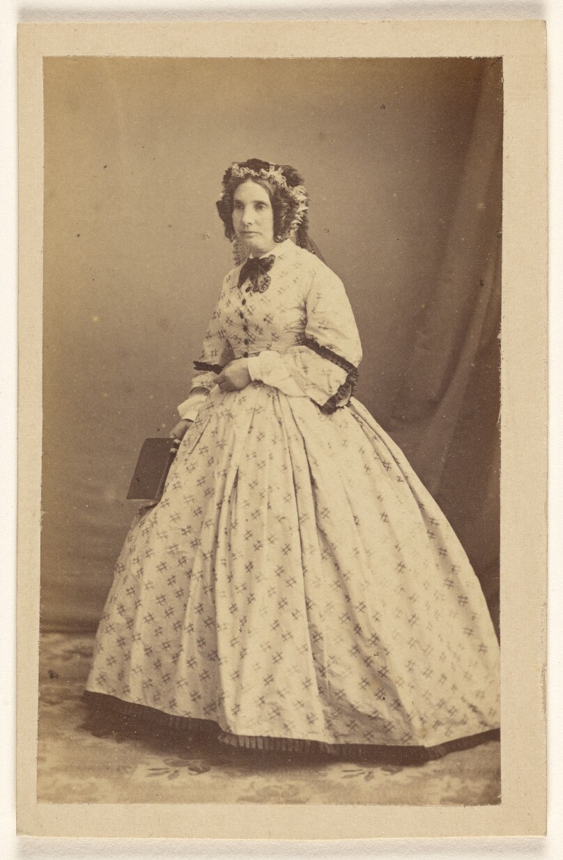 [Unidentified woman in white dress, standing]