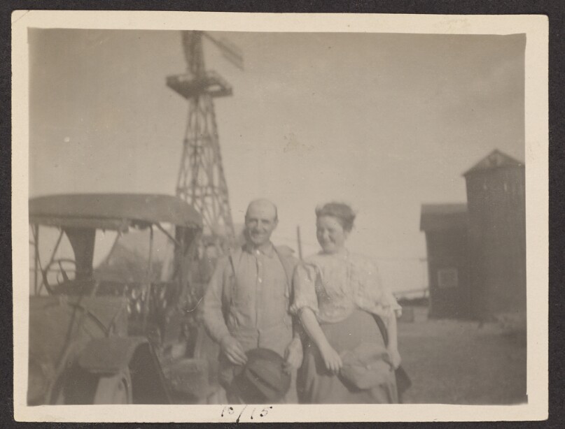 [Man and woman pose on farm]