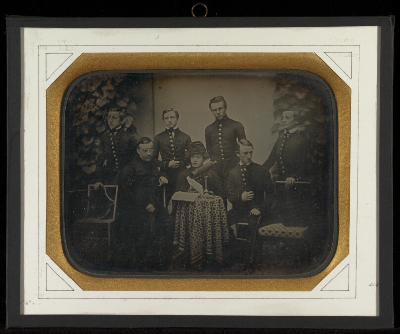 [Portrait of six boys in military school uniforms with their headmaster at Beaulieu]
