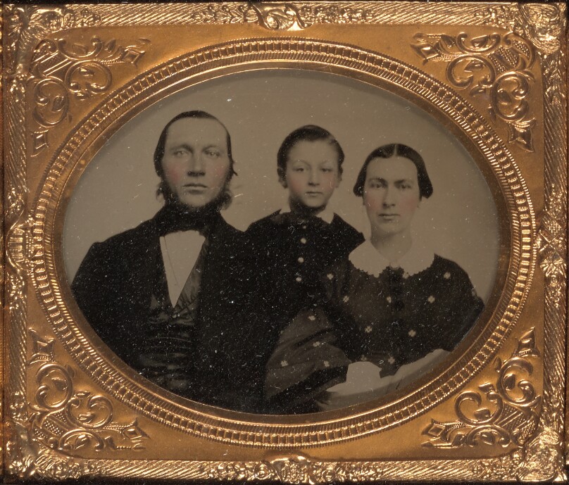[Family portrait of three members]