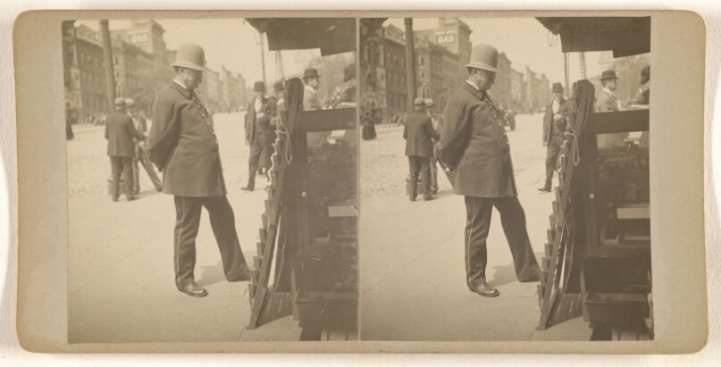 [Policeman on Albany, N.Y. street reading newspapers on rack]