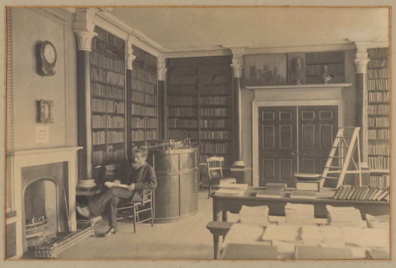 [Man reading in library]