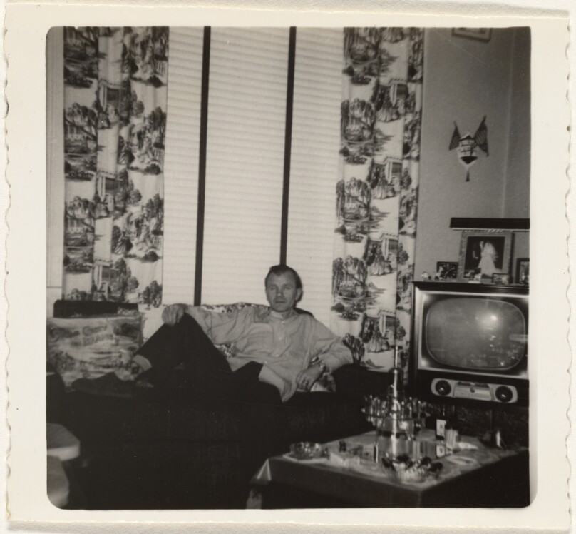 [Man reclining by television]