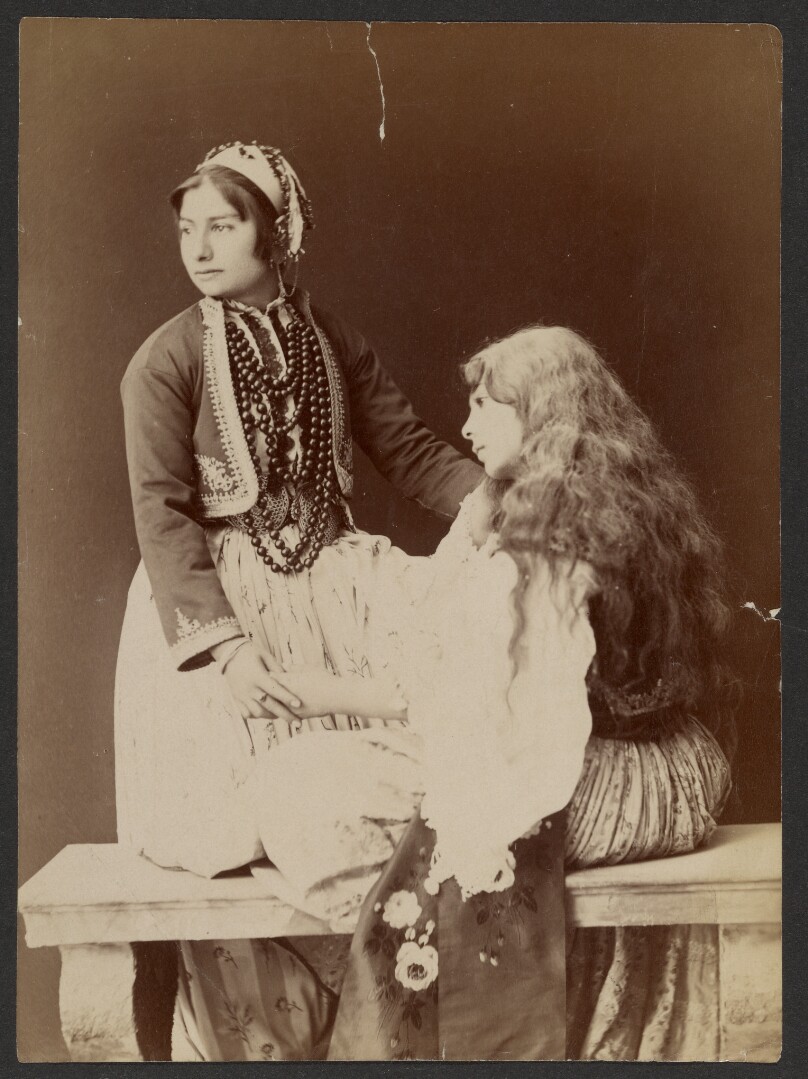 [Two women holding hands]