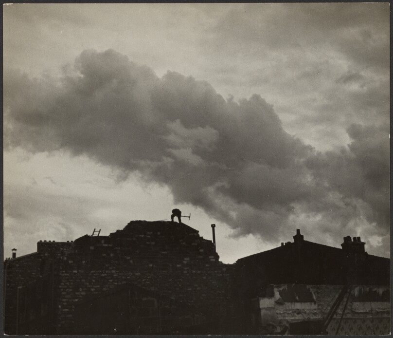 [Man with Pickaxe on Building]