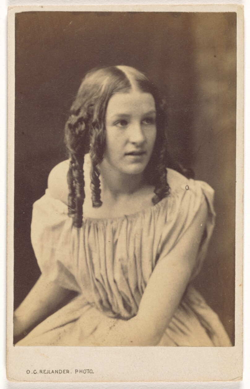 [Seated Young Woman With Hair in Curls]
