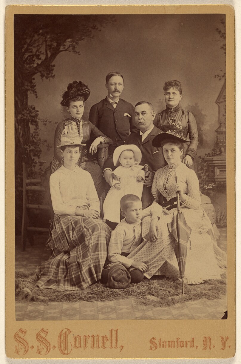 [Group family portrait of eight members]