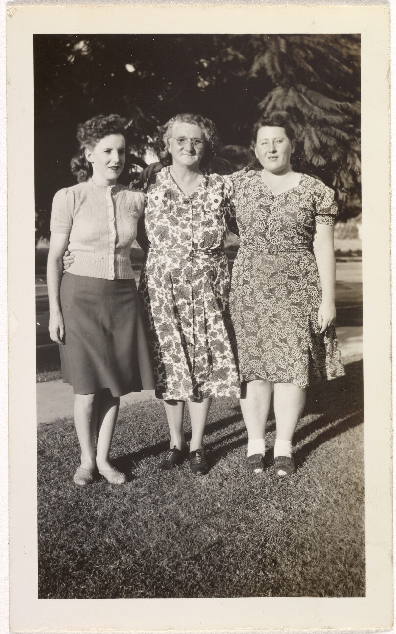 [Three women standing on lawn]