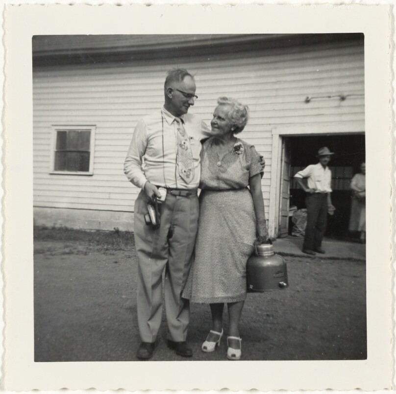 [Man and woman with camera and canteen]