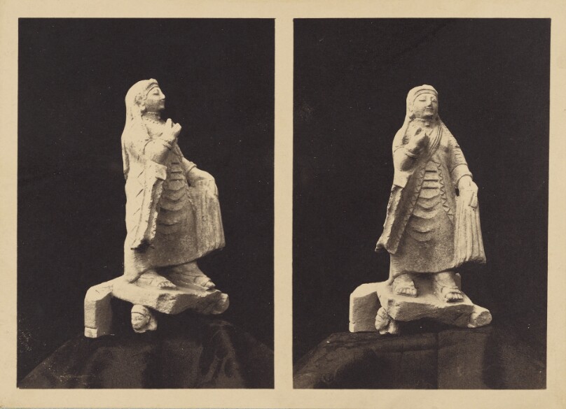 A small Figure of a Dancing Priestess of Aphrodite in two views; the pedestal supported by heads