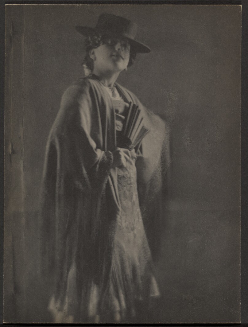 [Roma Girl Wearing a Long Dress, Shall, Hat, and Hold a Fan]