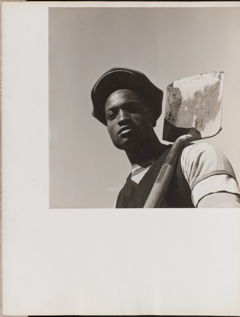 [Portrait of a man holding a shovel over his left shoulder]