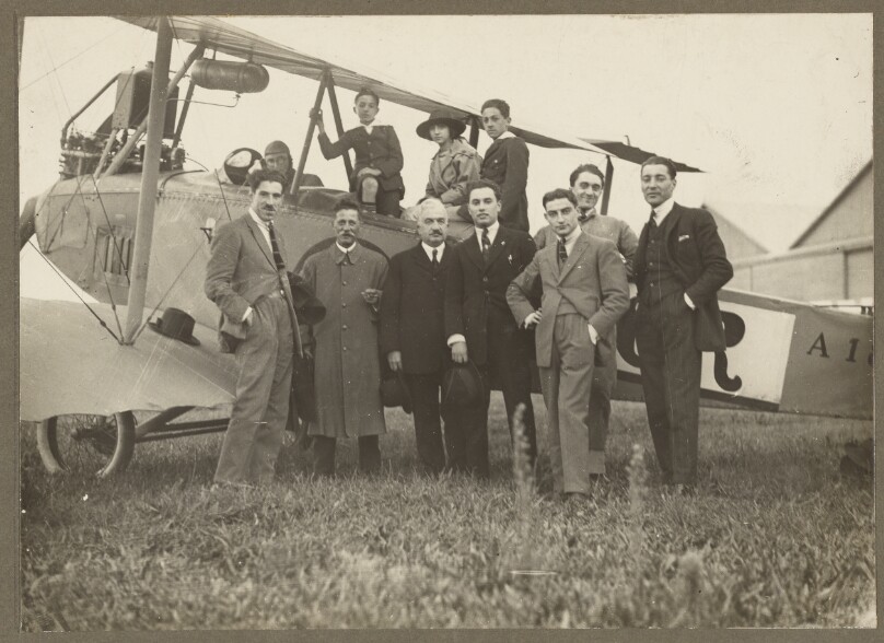 [Group portrait in front of plane]
