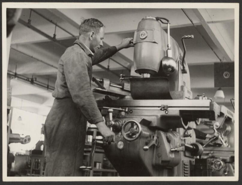 Man Working to the Left of a Machine