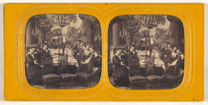 [Group of people seated around a dining table]