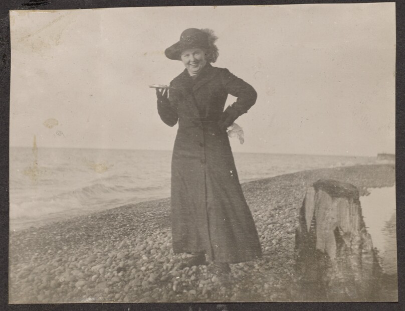 [Woman posing on a beach]