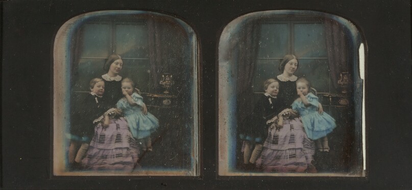 [Mother posed with her young son and daughter]