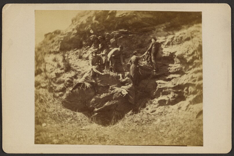 [Six male students with Eakins rock climbing]