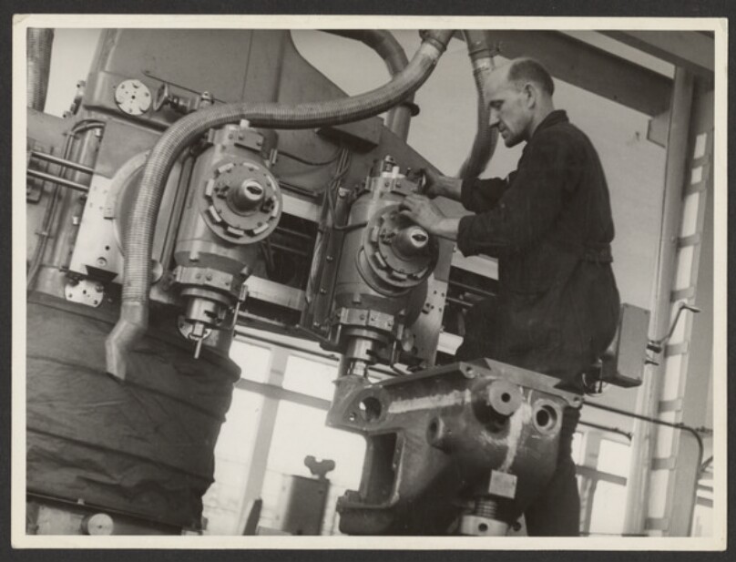 Man Working to the Right of a Machine