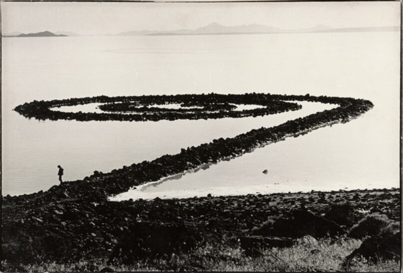 Robert Smithson standing on Spiral Jetty, view from the hill, Great Salt Lake, Utah