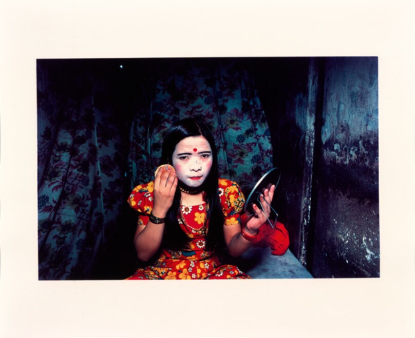 Nepalese girl powdering her skin, Falkland Road, Bombay, India