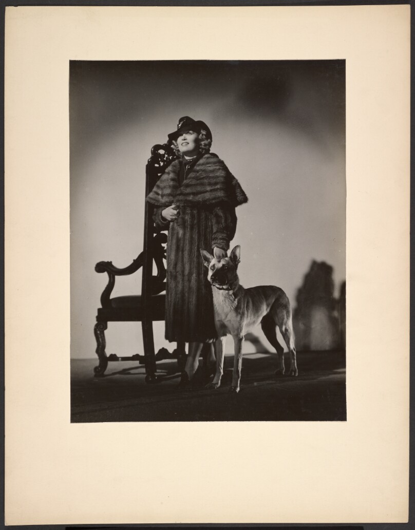 [Woman in fur coat with dog]