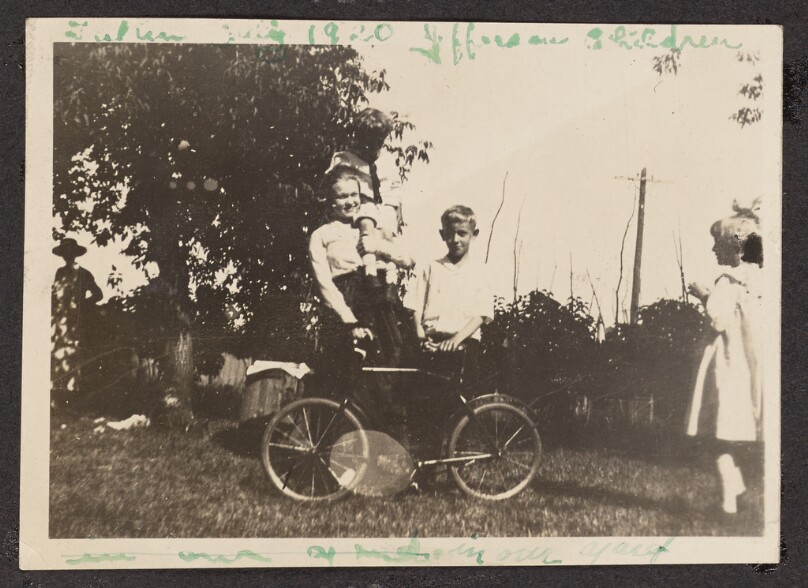 [Children posing with a bicycle]