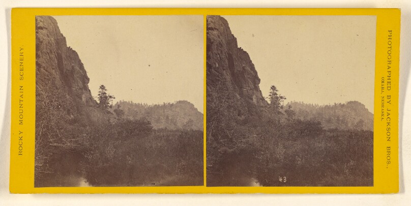 [Unidentified valley with cliffs to left]