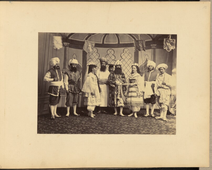 [Group portrait of men and women in costumes]