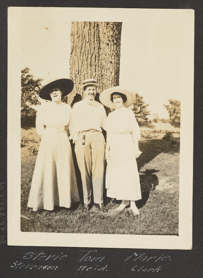 [A Man and Two Women Posing in Front of a Tree]