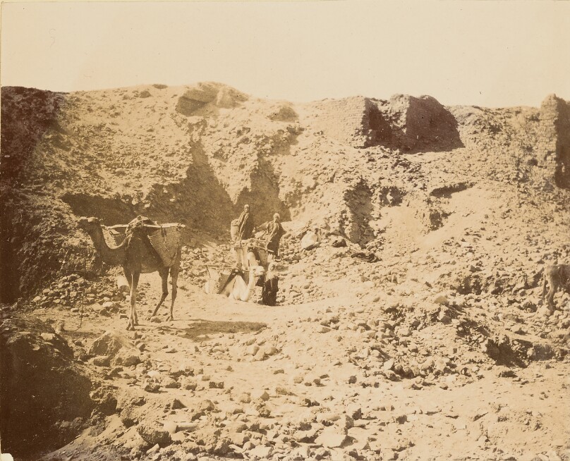 [Men with camel in desert]