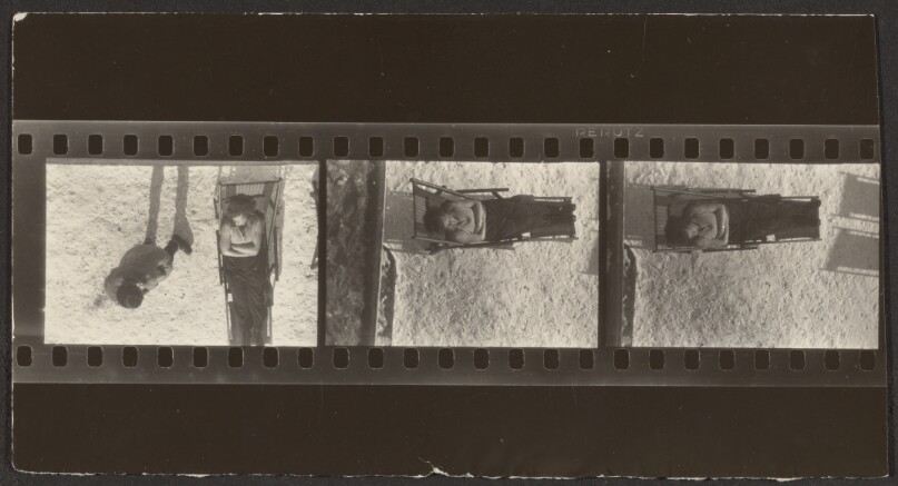 [Contact print strip from three Leica negatives: Man on top standing and woman seated on deck chair on beach viewed from above with woman on deck chair in middle and bottom]