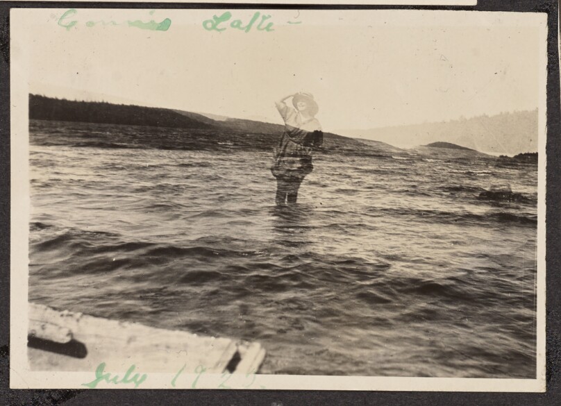 [Woman wading in a lake]