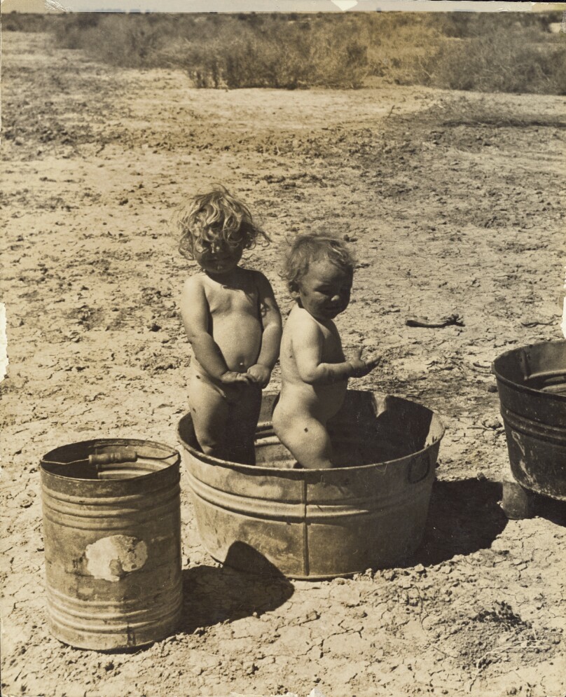 [Two children bathing in camp]