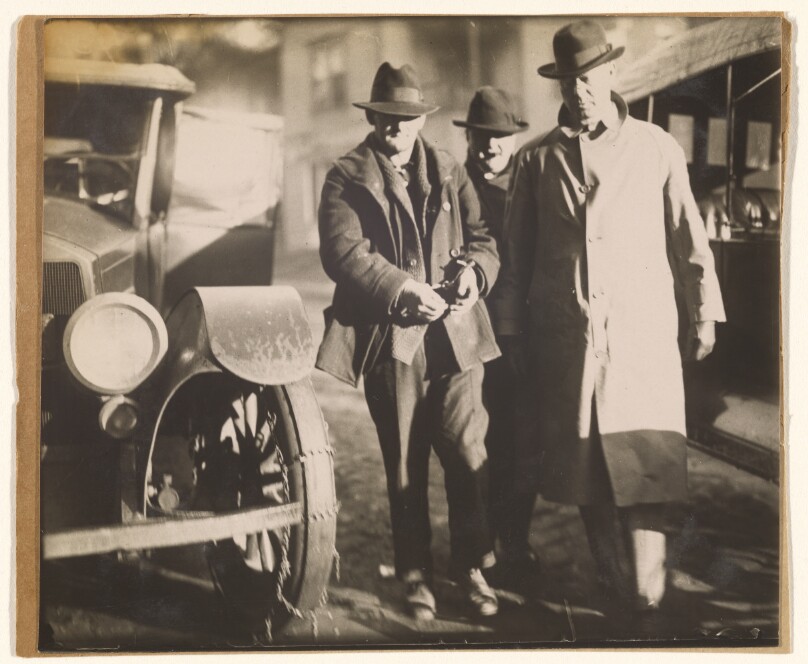 Captured Bootlegger in Handcuffs with Federal Officers