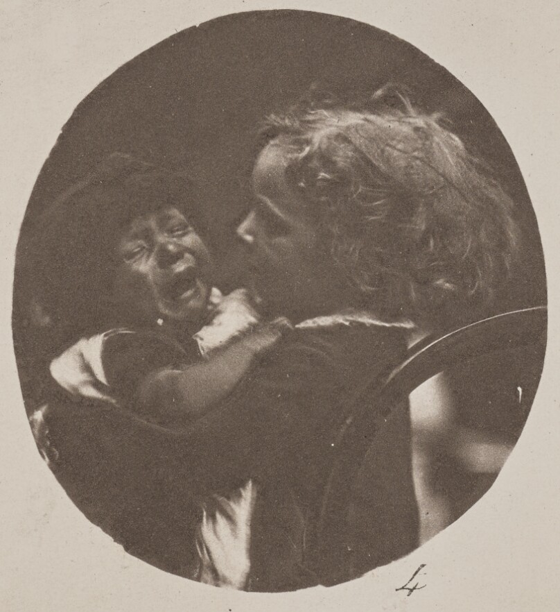 [Child holding crying baby]