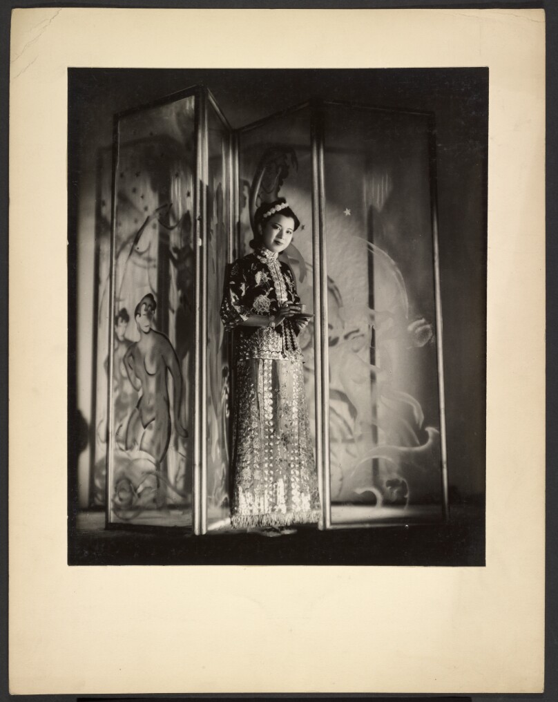 [Woman posed in front of screen with tea]