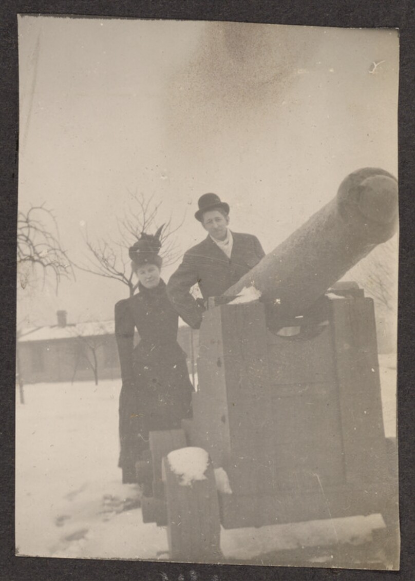 [Man and woman pose with a cannon]