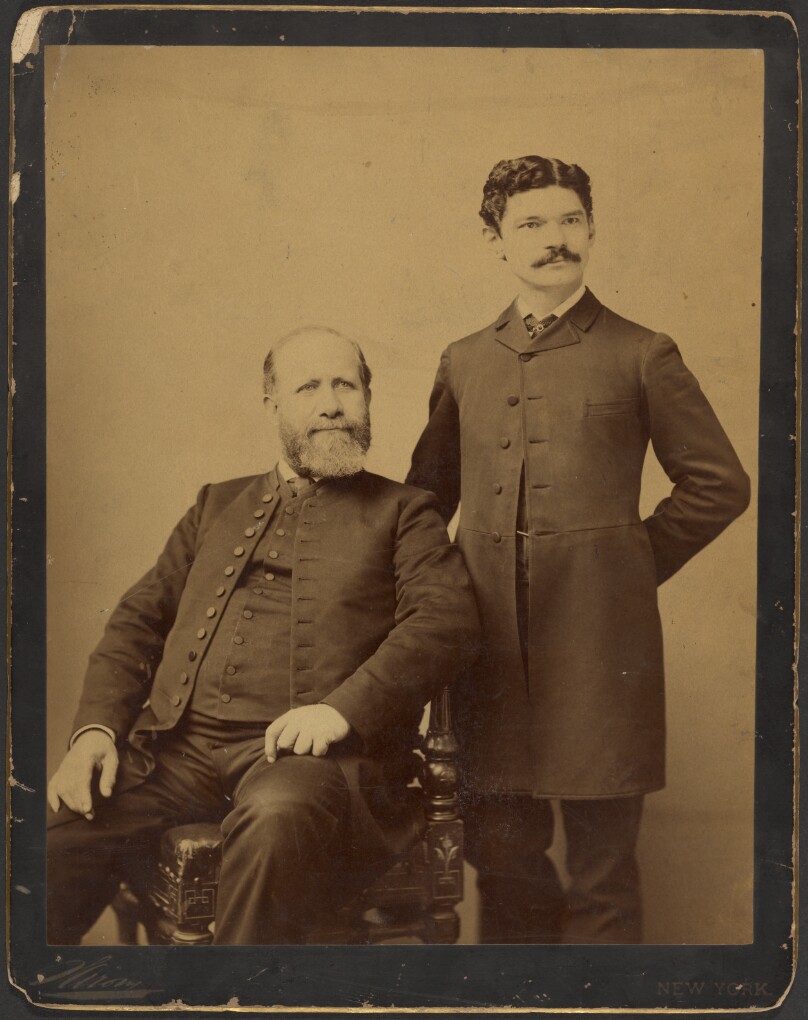 [Unidentified bearded man seated with unidentified man with moustache standing]