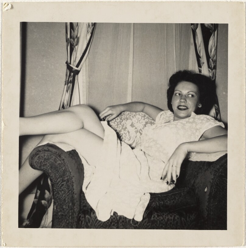[Woman reclining in armchair]