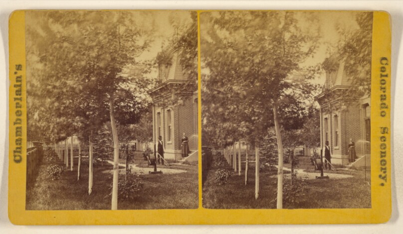 [Man mowing lawn with hand mower, woman standing on steps, with house, garden and trees, somewhere in Colorado]