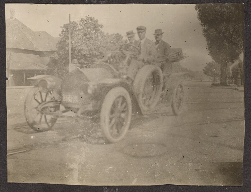 [Three men in a car]