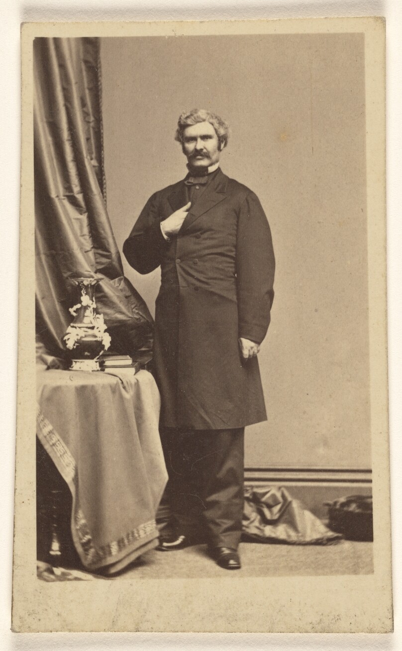 [Unidentified man with moustache standing in Napoleonic stance]