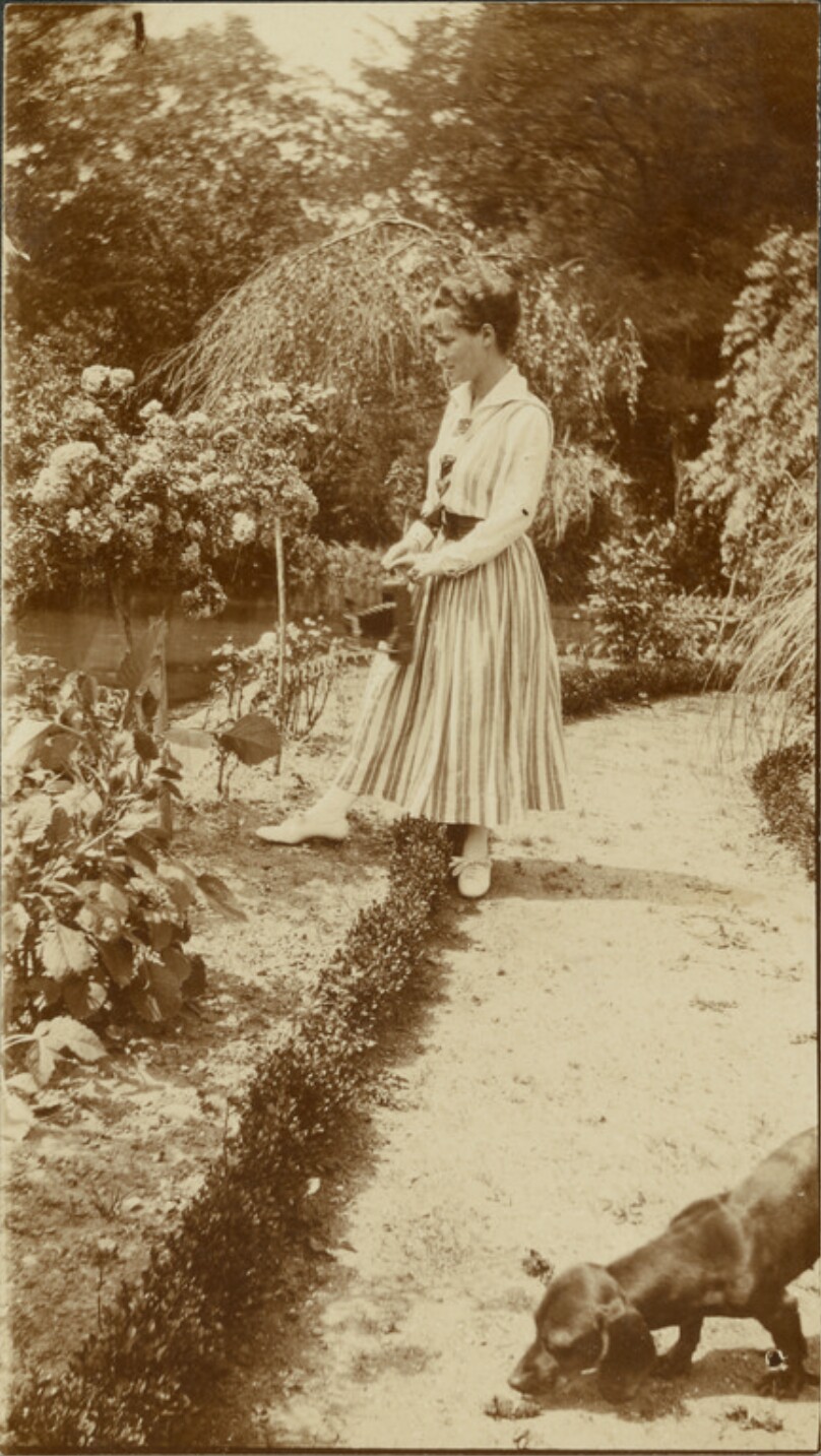 [Woman with camera in garden]
