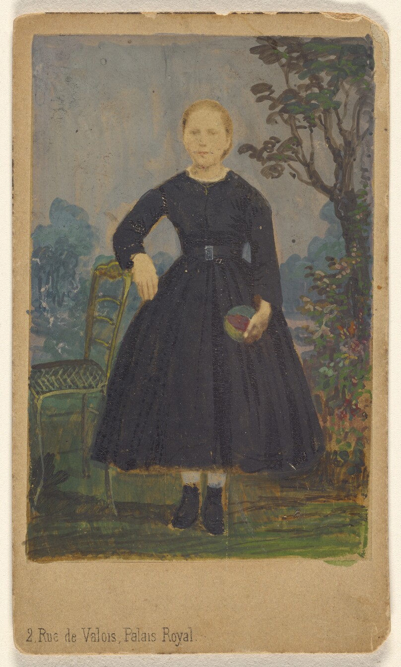 [Unidentified young woman standing, holding a ball]