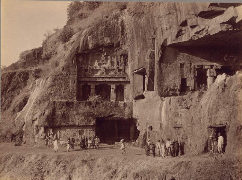 Carvings within Face of Cliff, Onlookers in Foreground [Deowara Caves, Ellora]
