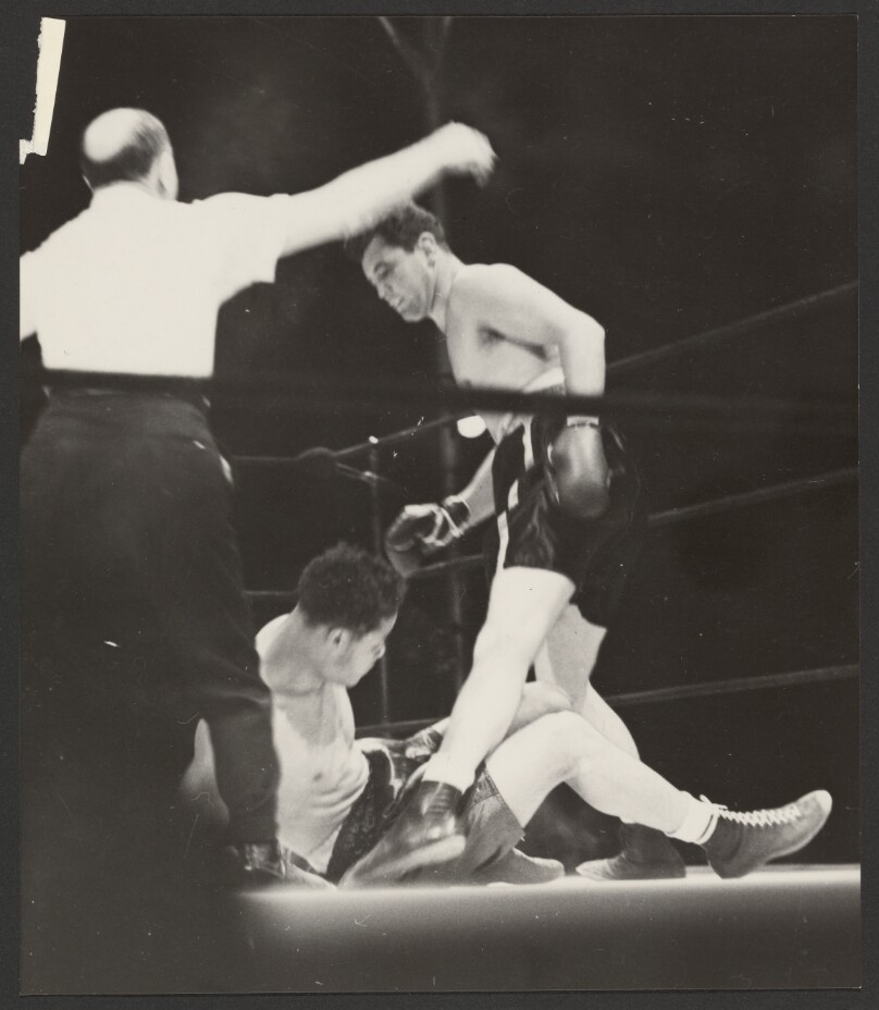 [Boxer standing over his fallen opponent]
