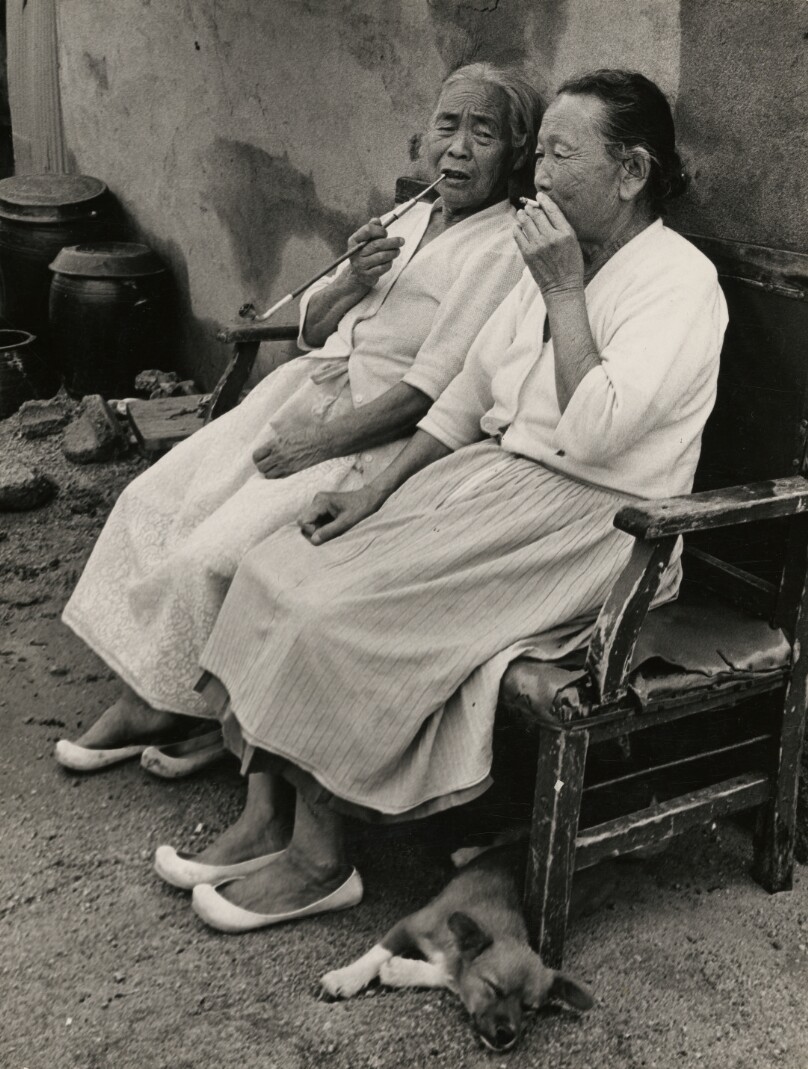 Two Seated Women Smoking