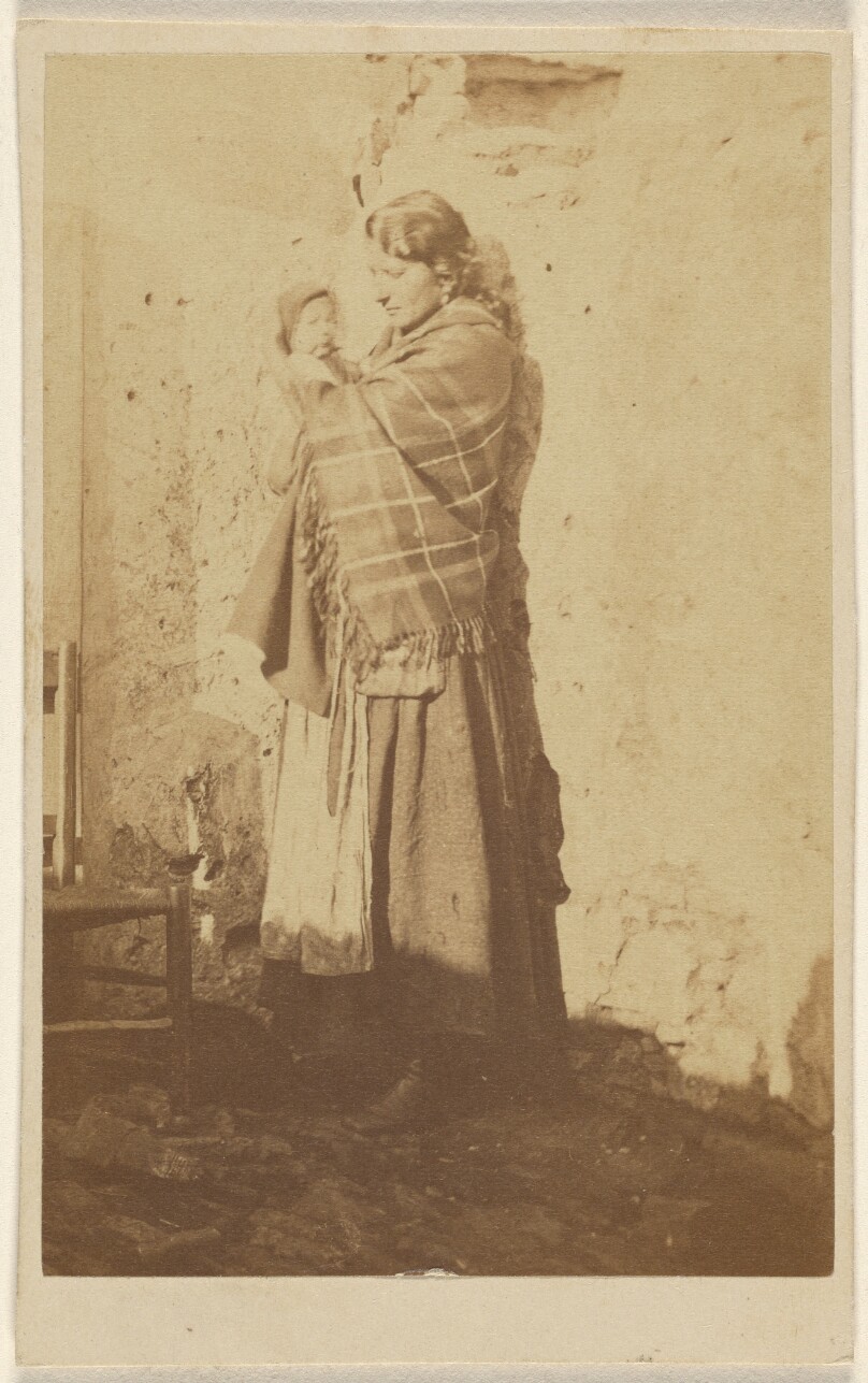 [Unidentified woman wearing a shawl, holding a baby]