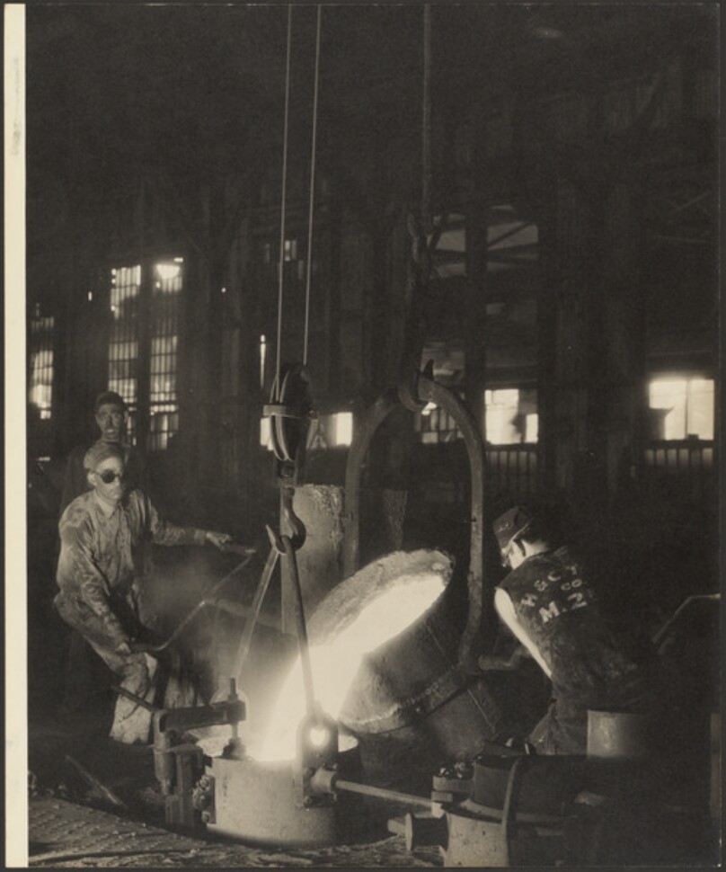 [Workers pouring melted metal]